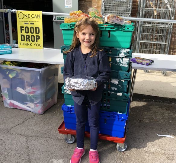 Six-year-old Aurelia with the donations 